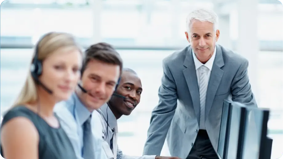 Call center team smiling while looking at the camera